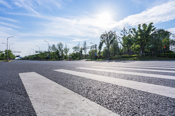 empty asphalt road with city skyline