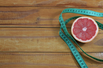 Grapefruit and slimming tape on the table, a symbol of weight loss and diet