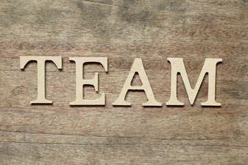 English alphabet in word team on wood background