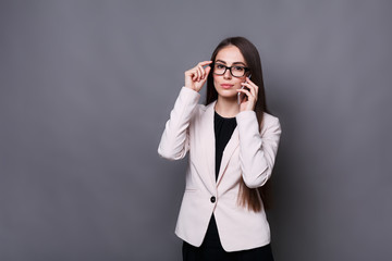 Confident brunette business lady talking on cell phone