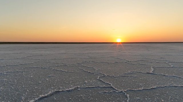 Sunset time lapse on the Elton lake. Salt desert on a beach of Elton lake.