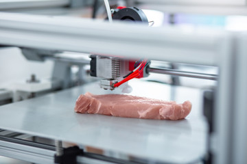 Perfect imitation. The close up of a modern 3D printer making a piece of meat and imitating all the...