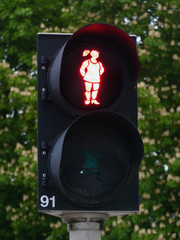 Red pedestrian light with a walking happy girl in Amersfoort, Netherlands