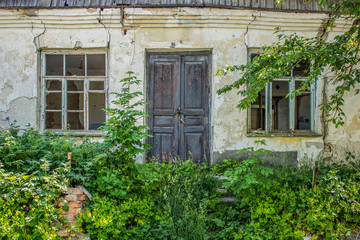 backstreet slum old poor house facade with crushed woode