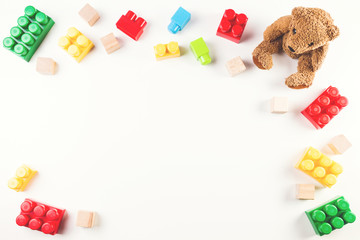 Kids toys background with teddy bear and colorful blocks