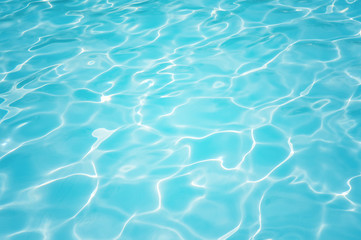 Fototapeta na wymiar Blue and bright ripple water and surface in swimming pool, Beautiful motion gentle wave in pool
