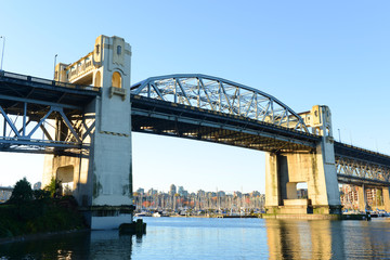 Fototapeta na wymiar Vancouver Burrard Bridge is an Art Deco style bridge crossing False Creek between downtown Vancouver and Kitsilano, British Columbia, Canada.