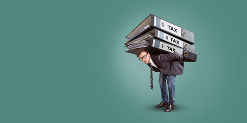 Man carrying a giant stack of tax folders