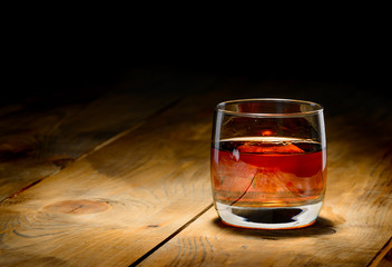 whiskey with ice on a wooden table