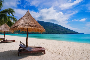 Beautiful beach.lounge chairs on the sandy beach near the sea.holiday and vacation concept.