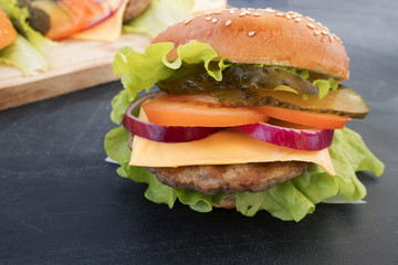 A beautiful homemade hamburger on a gray background