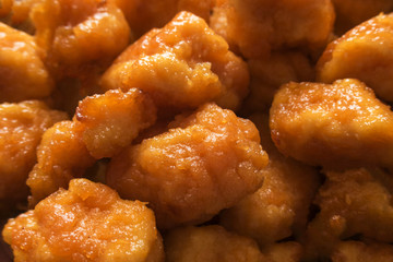 Appetizing and tasty fried chicken pieces in battered close-up