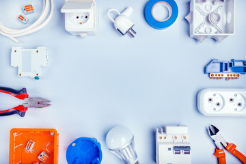 Different electrical tools on light grey background with plase for text, top view.