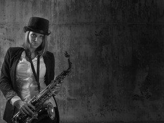 Young beautiful long haired blonde with saxophone.