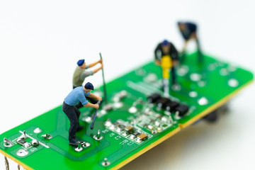Miniature worker repairing mainboard, clear virus computer and repair, security and technology concept.