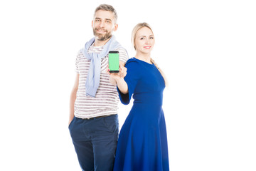 Casual couple showing phone on white background