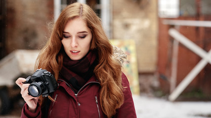 Portrait of beautiful red-haired photographer going on photo session