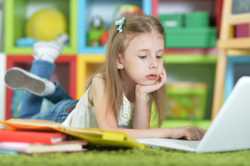 Cute schoolgirl doing homework