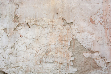 Old brick wall with shattered plaster