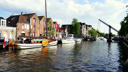malerische Gracht durch Sneek entlang Häusern und Schiffen und mit alter Stahlzugbrücke