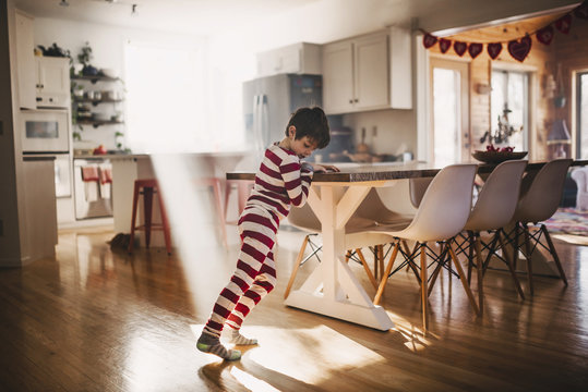 Boy dancing in the kitchen in his pyjamas