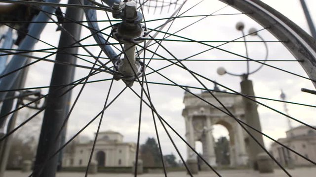 A bike parked in Sempione Square in Milan show a part of the arc