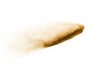 Golden sand explosion isolated on white background. Abstract sand cloud. Gold sand splash against on clear background. Sandy fly wave in the air.