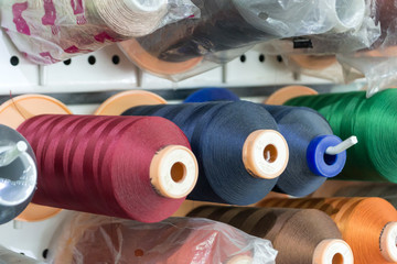 Bobbins with colored threads in the studio