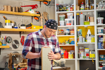 carpenter performs work on the wood