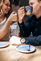 The romantic couple in love drinking cups of coffee