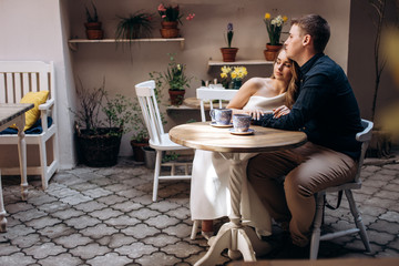 The romantic couple in love sitting in the restaurant