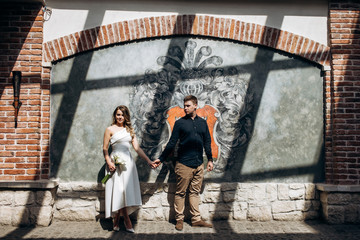 The romantic couple in love standing near ancient building