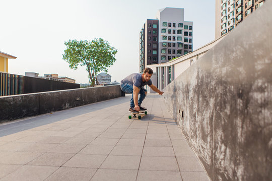 Young man riding skateboard on the street.