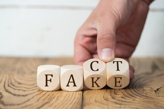 Hand is revealing that a "fact" is a "fake"