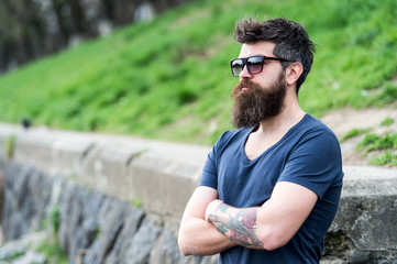 Barbershop and style concept. Man with beard and mustache on strict face, nature background,...
