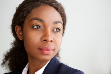 Close up young african businesswoman looking away and thinking