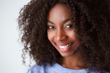 Close up smiling young african american woman against white background