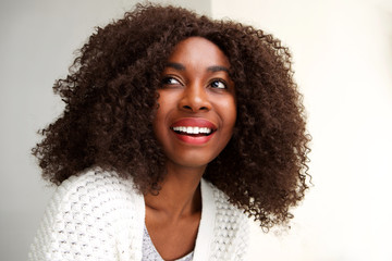 Close up happy young african woman looking away and smiling