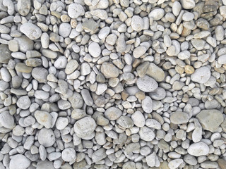 Sea round glossy stones background, top view.