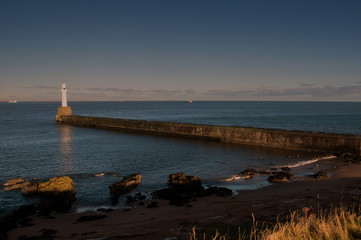 Light house at entrance to Aberdeen harbour, in winter