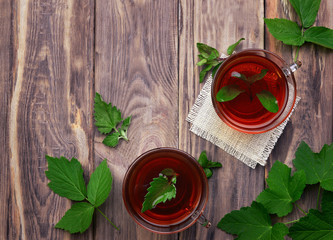 Cups of mint tea and leaves of mint on the table. Herb tea. Healing herbs.Top view. Food background.