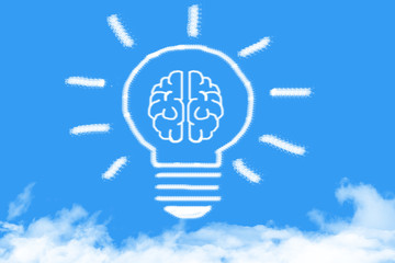 Light bulb with a brain cloud shaped on blue sky