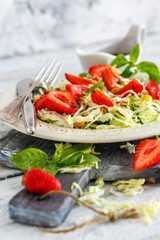 Salad with strawberries and balsamic sauce.
