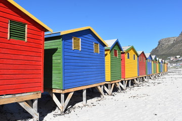 Fototapeta na wymiar Colorful bathing cabins on the beach in Muizenberg in Cape Town, South Africa