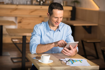 businessman using digital tablet in cafe