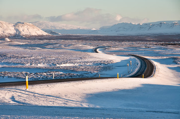 Empty road at sunset in winter landscape of Iceland, European travel destination