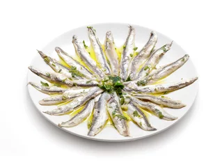 Poster Delicate Marinated anchovies with parsley, olive oil and vinegar isolated on white background. © Shootdiem
