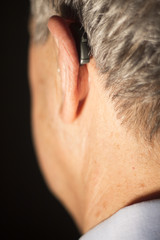 Deaf man hearing aid ear