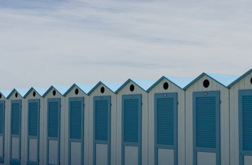 wooden beach cabins by the sea, changing rooms, blue and white, used to change and put on bathing suit, vacation, summer, sun, ligurian riviera, Albenga beach, Italy