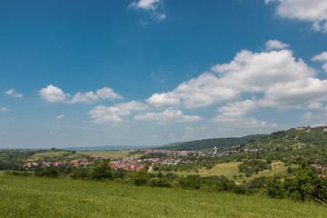 Little village in the middle of the german countryside with forests, fields and meadows